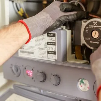Halsted technician servicing a water heater control panel