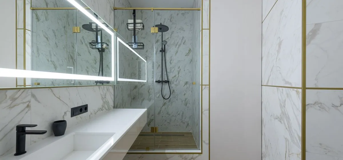 Finished bathroom remodel with walk-in shower and marble tile