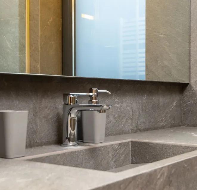 Chrome faucet and stone counter after a kitchen fixture replacement